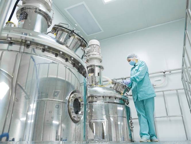 A researcher in protective clothing interacting with research infrastructure